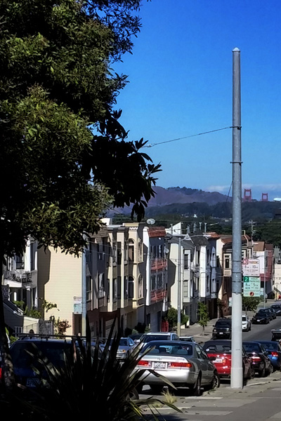 The Golden Gate Bridge just barely visible in the distance from the corner of 9th and Lawton