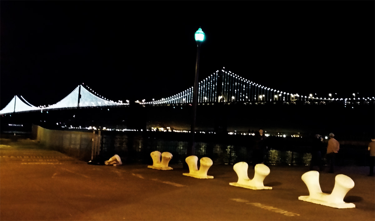 The Bay Bridge lit up at night.