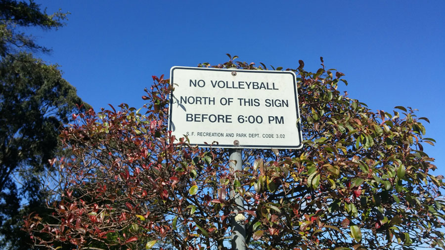 A sign restricting where and when volleyball can be played.