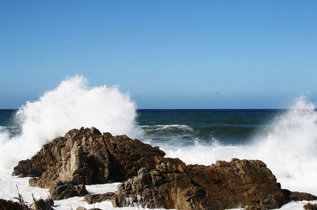 A wave crashing into the rocks.
